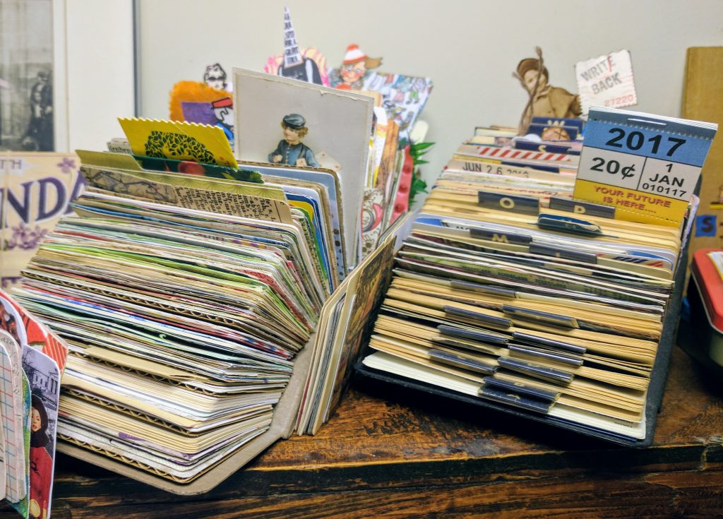 a display of collaged cards in a rolodex file