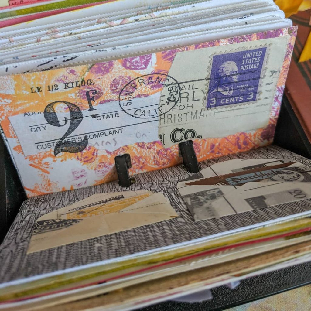 some mail-art collaged Rolodex cards in purple and orange