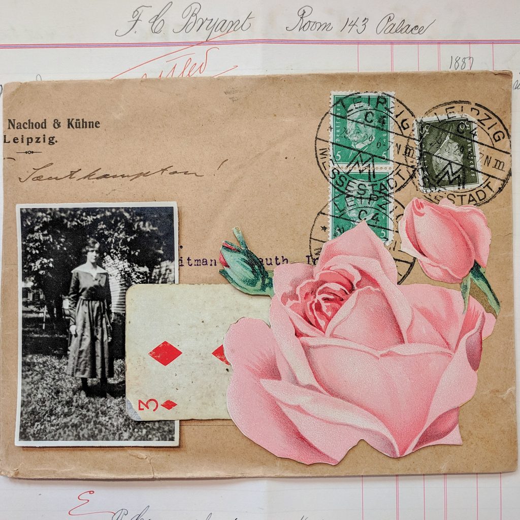 a vintage envelope collaged with a rose, a playing card and a photo