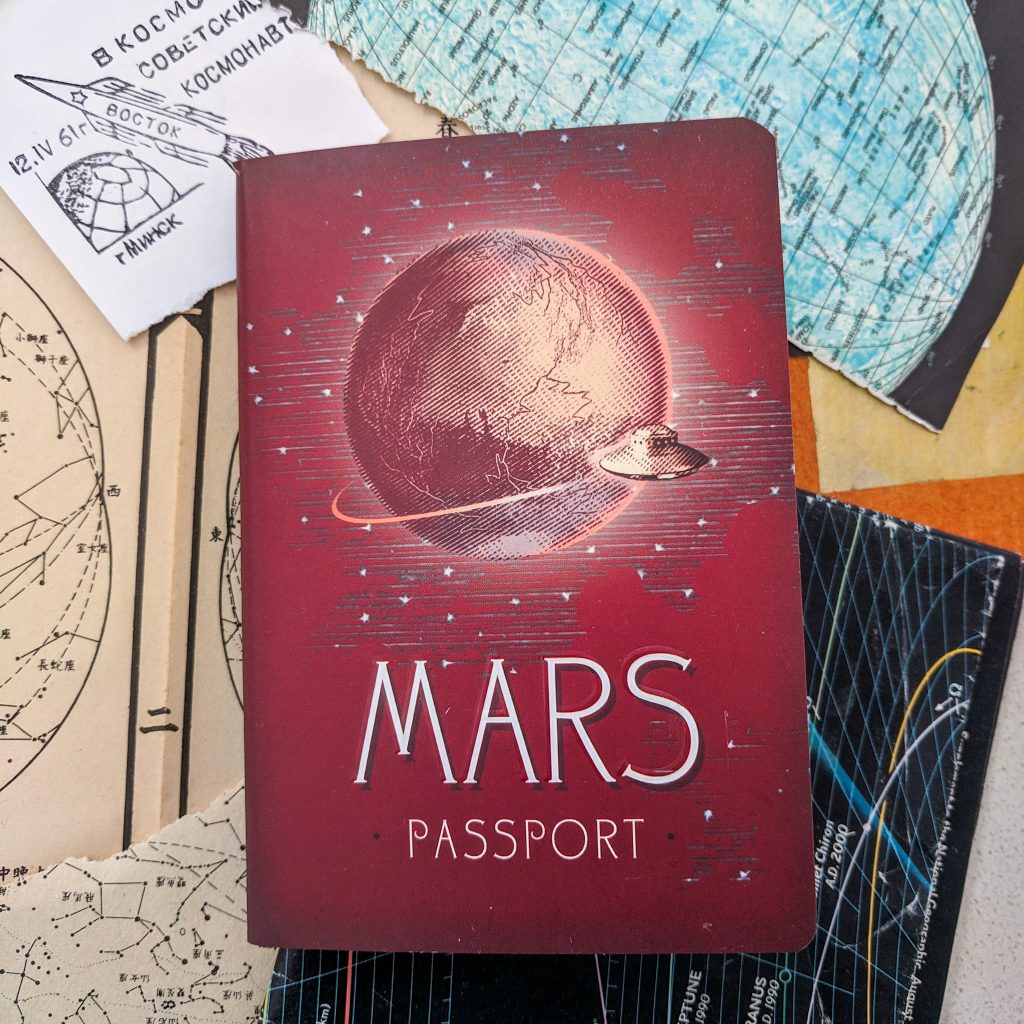 A "Mars Passport" sits atop a stack of space-related papers