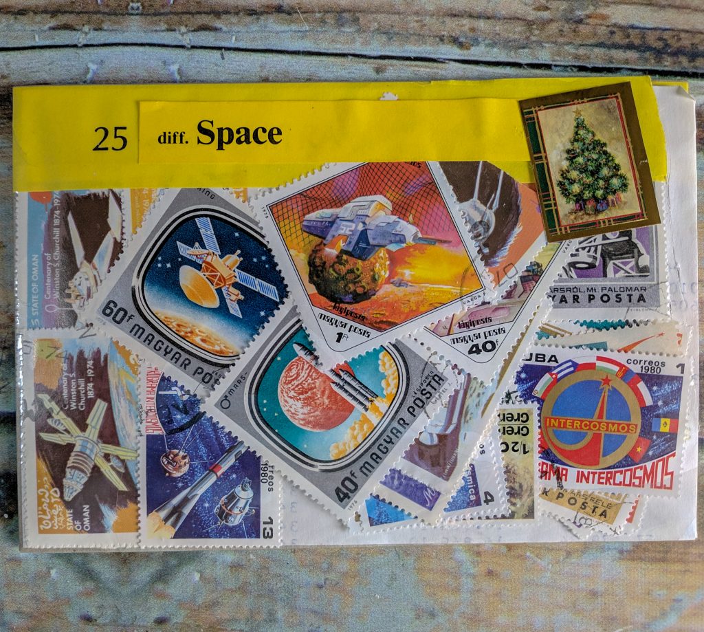 a small plastic envelope filled with space-related postage