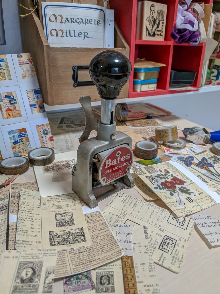 A table top is covered with art scraps for collaging