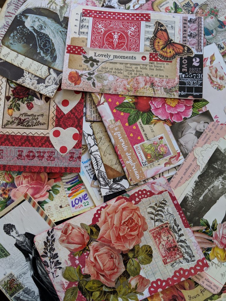 a huge pile of pink and red colored "love" postcards