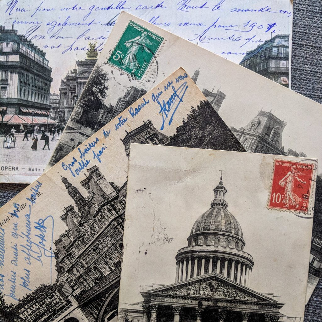 old postcards with architecture on the front. Many have visible handwriting on them