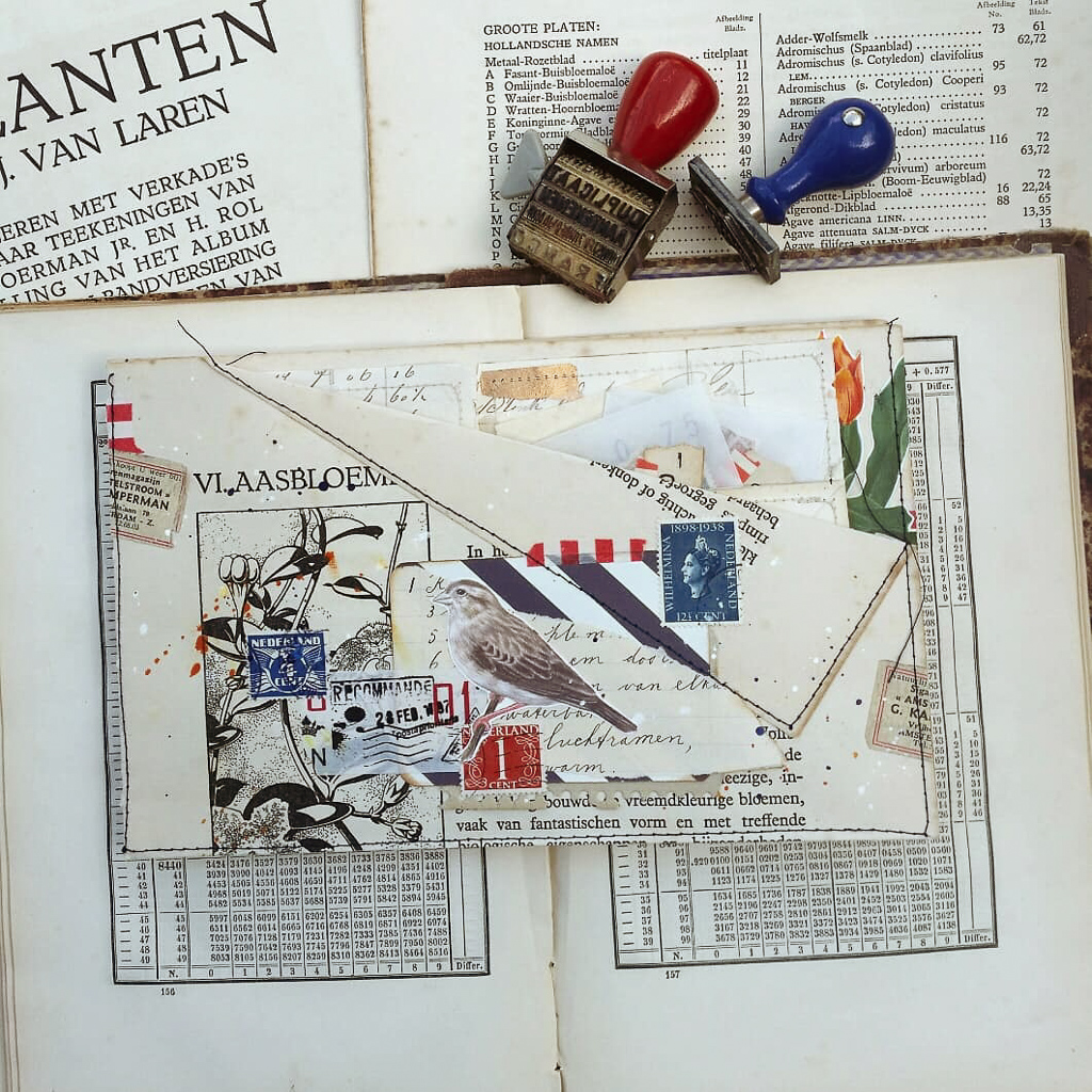 A folio of vintage ephemera lies on a book