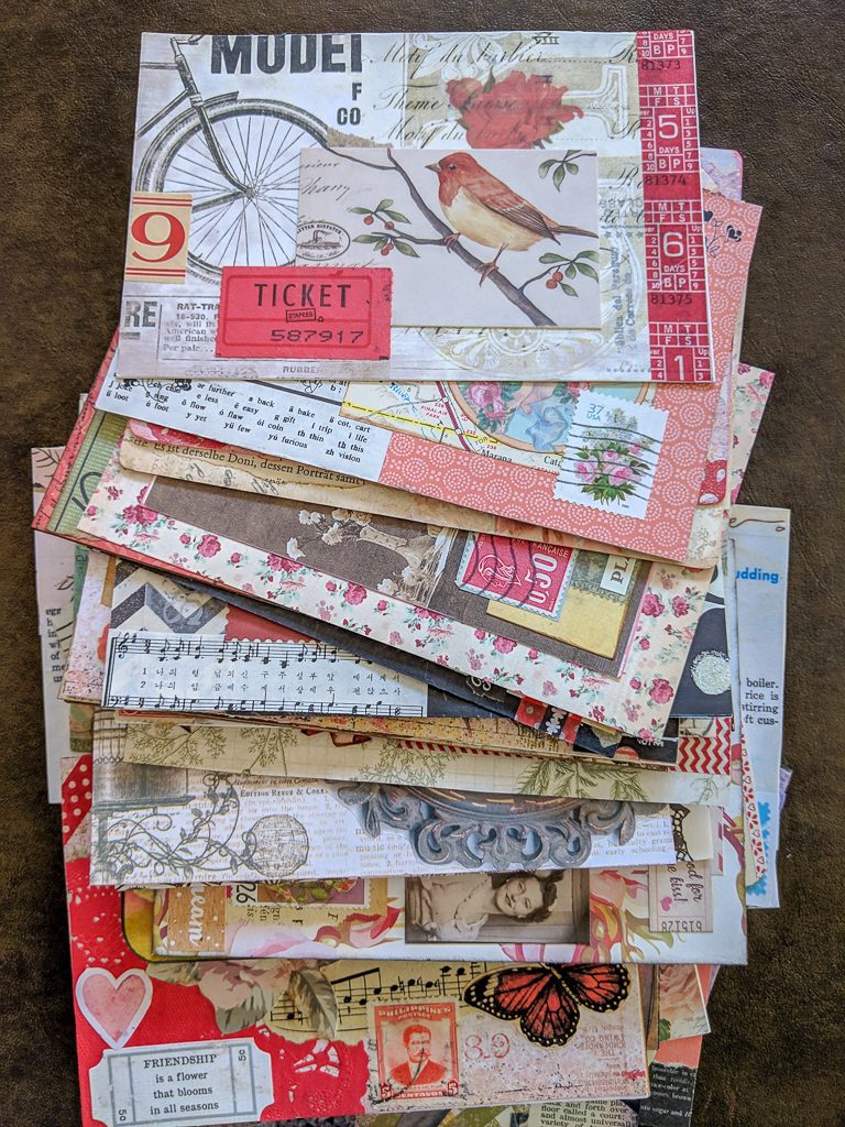 a stack of collage-art postcards, all done in a vintage style