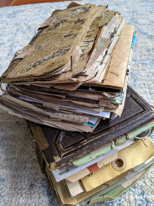 Two chunky journals stuffed with vintage papers