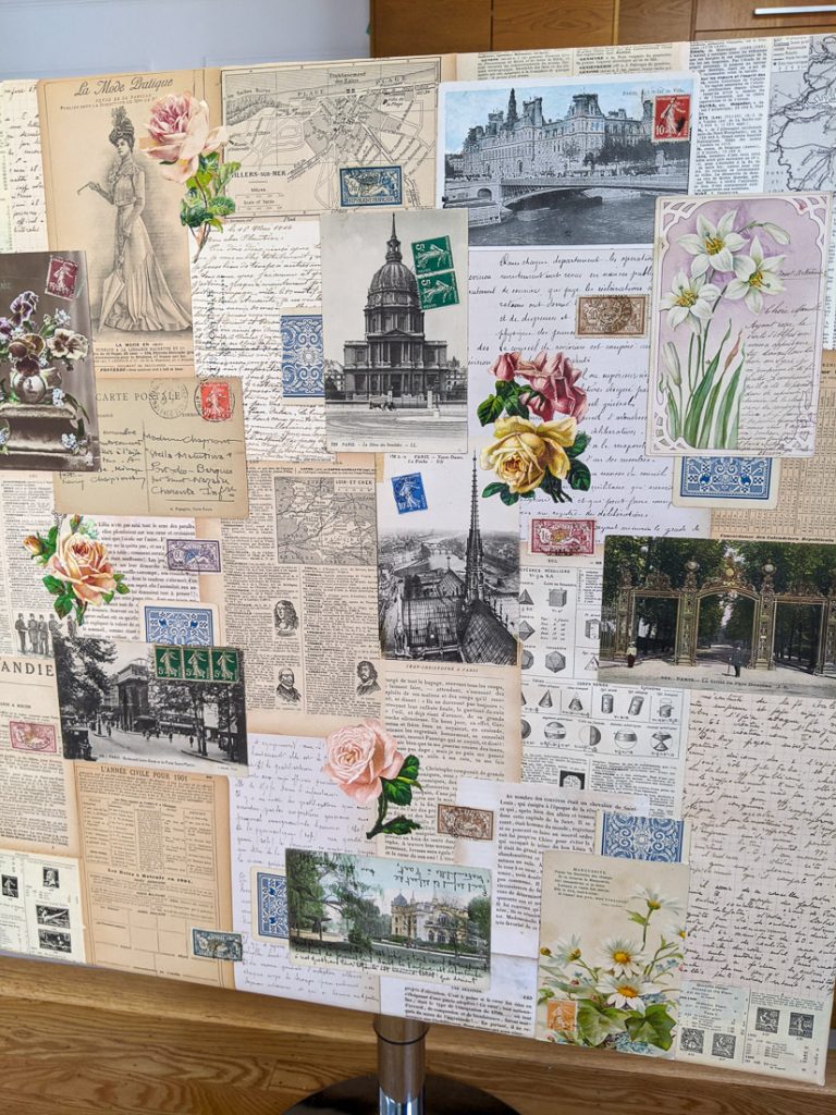 A canvas collaged with vintage French papers and postage stamps.