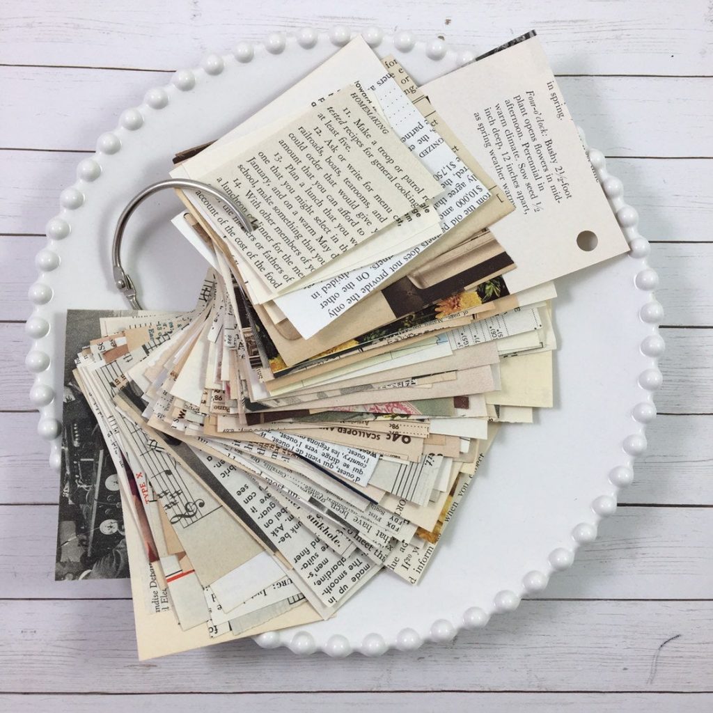 a metal ring holds a stack of vintage scrap papers